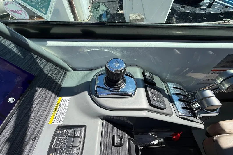 Slide: The Image of Control panel of a 2013 Formula 310 Bowrider boat, featuring joystick and throttle controls. - 39