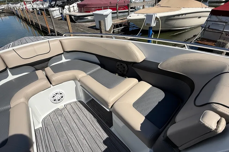 Slide: The Image of 2013 Formula 310 Bowrider boat interior with beige seating at a marina. - 47