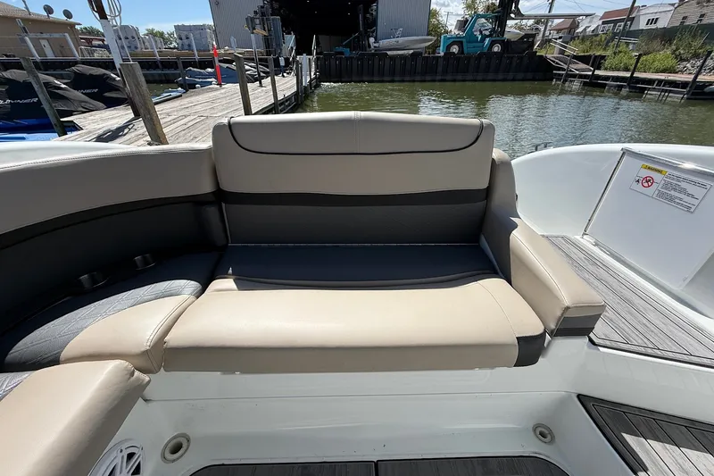 Slide: The Image of 2013 Formula 310 Bowrider boat interior with beige seating at dockside. - 19