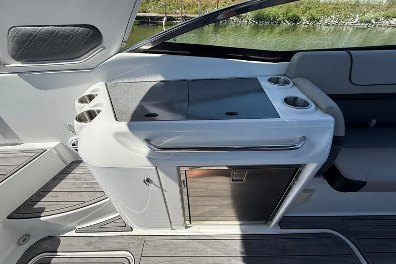 Slide: The Image of 2013 Formula 310 Bowrider interior with sleek kitchenette and cup holders. - 23