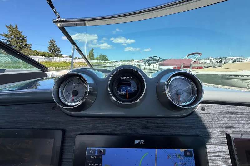 Slide: The Image of Dashboard view of a 2013 Formula 310 Bowrider boat with gauges and navigation display. - 37