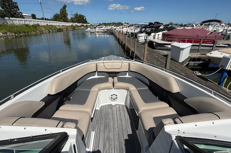 Slide: The Image of 2013 Formula 310 Bowrider docked at marina, featuring spacious seating and sleek design. - 46