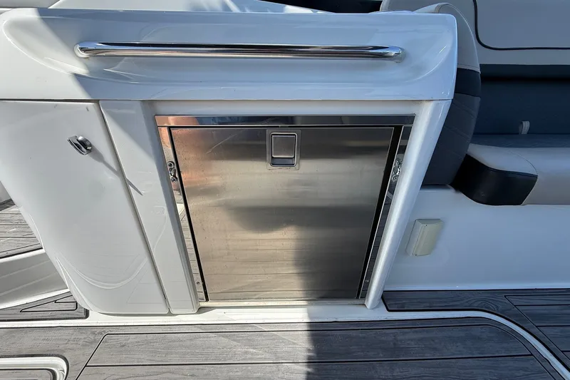 Slide: The Image of 2013 Formula 310 Bowrider interior with stainless steel cabinet and seating area. - 24