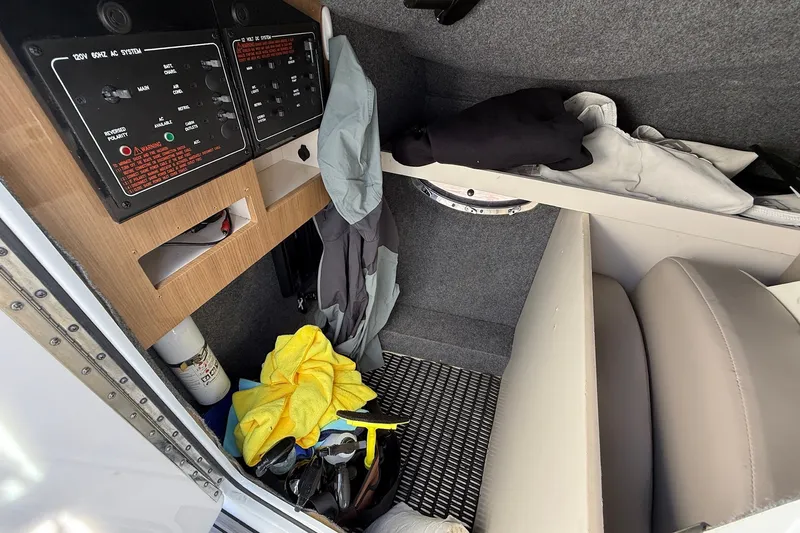 Slide: The Image of Interior of 2013 Formula 310 Bowrider boat with control panels and storage area. - 53