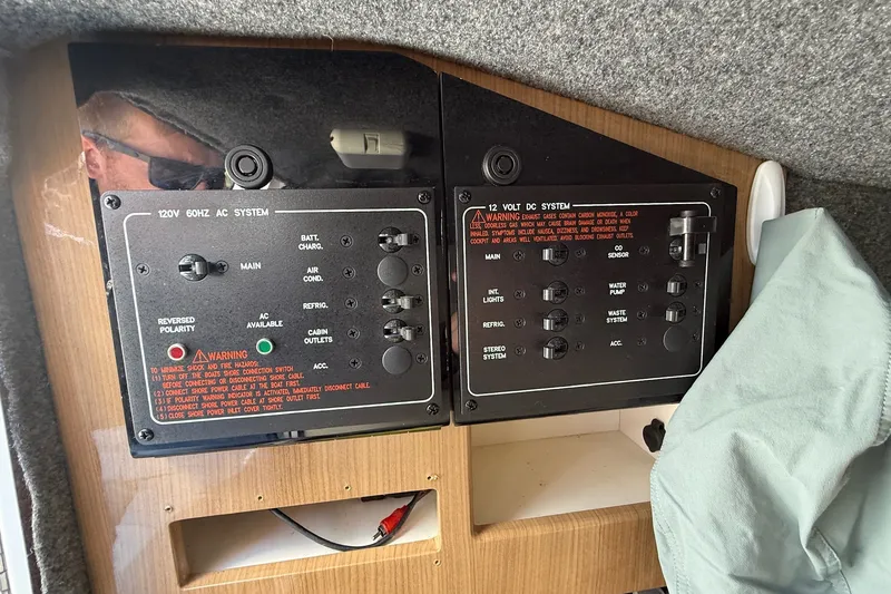 Slide: The Image of Control panel of a 2013 Formula 310 Bowrider boat, featuring AC and DC systems. - 54