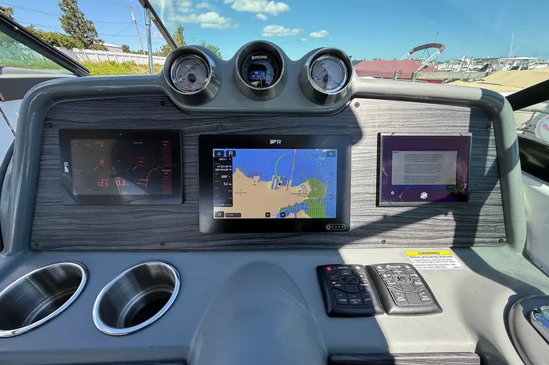 Slide: The Image of Dashboard of a 2013 Formula 310 Bowrider with navigation and control displays. - 33