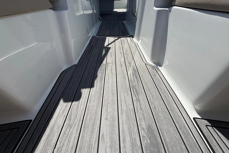 Slide: The Image of 2013 Formula 310 Bowrider deck with sleek, modern design and wood-like flooring. - 51