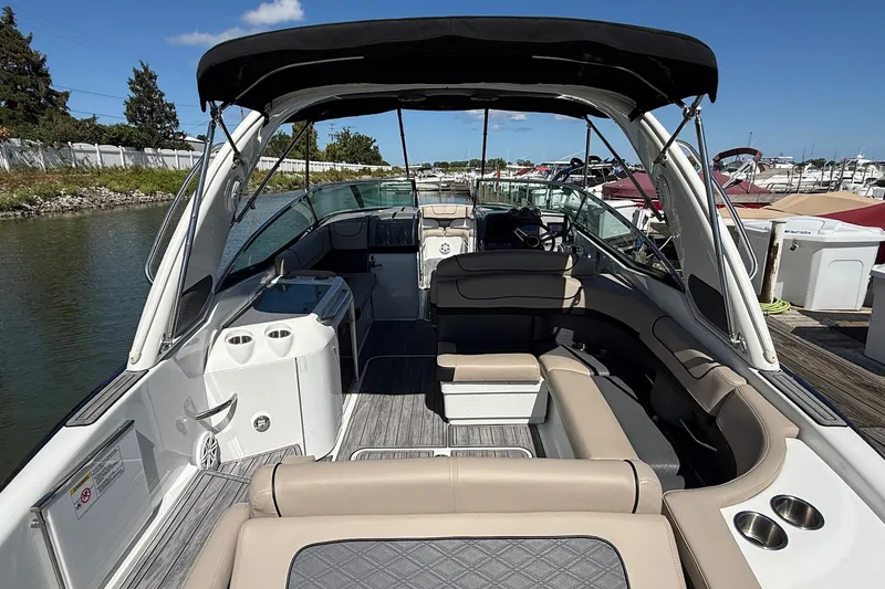 Slide: The Image of 2013 Formula 310 Bowrider boat with spacious seating and sleek design at a marina. - 15