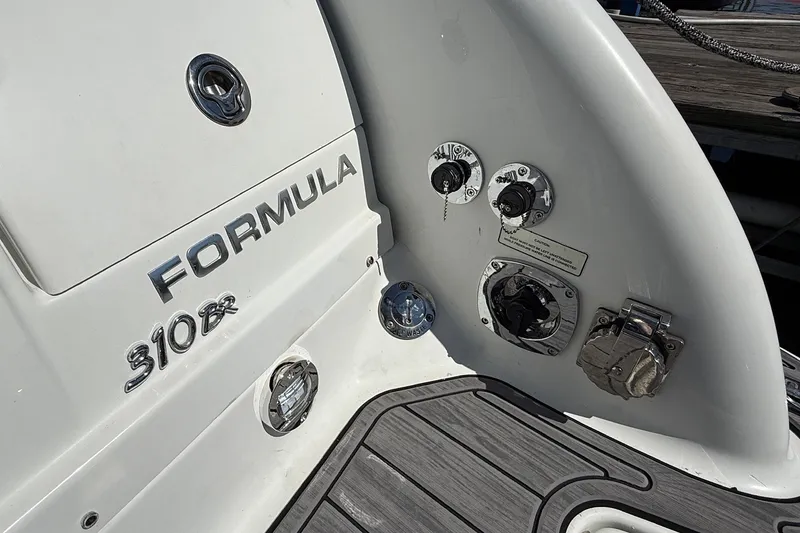 Slide: The Image of 2013 Formula 310 Bowrider boat stern with control panel and branding. - 14