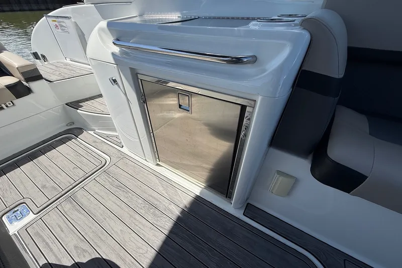 Slide: The Image of 2013 Formula 310 Bowrider interior with sleek stainless steel fridge and modern seating. - 26