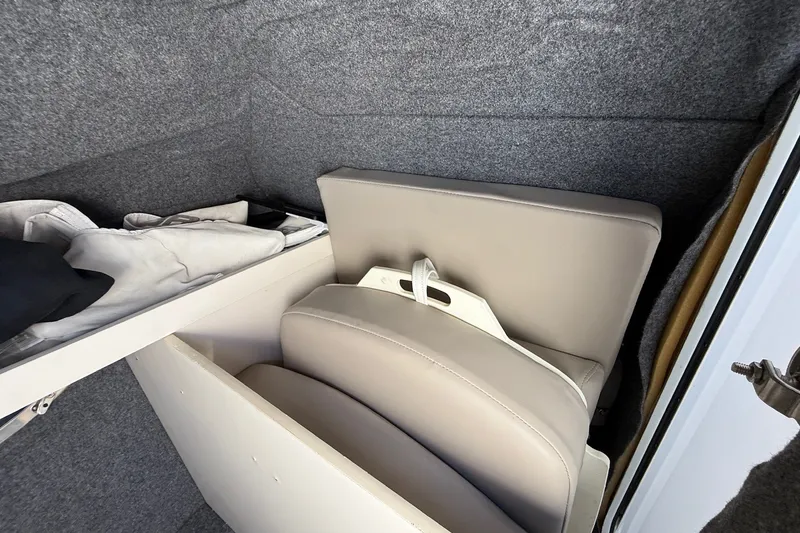 Slide: The Image of Storage compartment in 2013 Formula 310 Bowrider with cushions and clothing. - 55