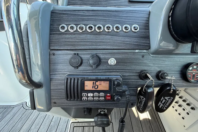 Slide: The Image of Dashboard of a 2013 Formula 310 Bowrider with VHF marine radio and controls. - 40