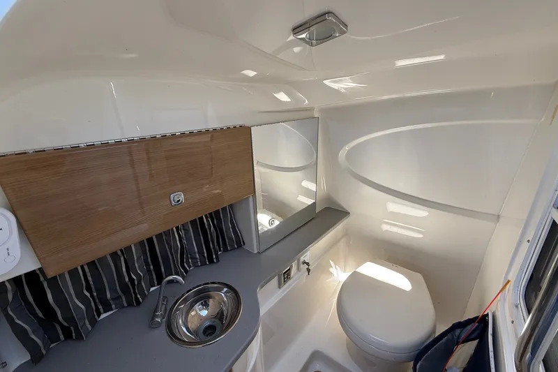 Slide: The Image of Interior of 2013 Formula 310 Bowrider boat bathroom with sink, toilet, and mirror. - 42