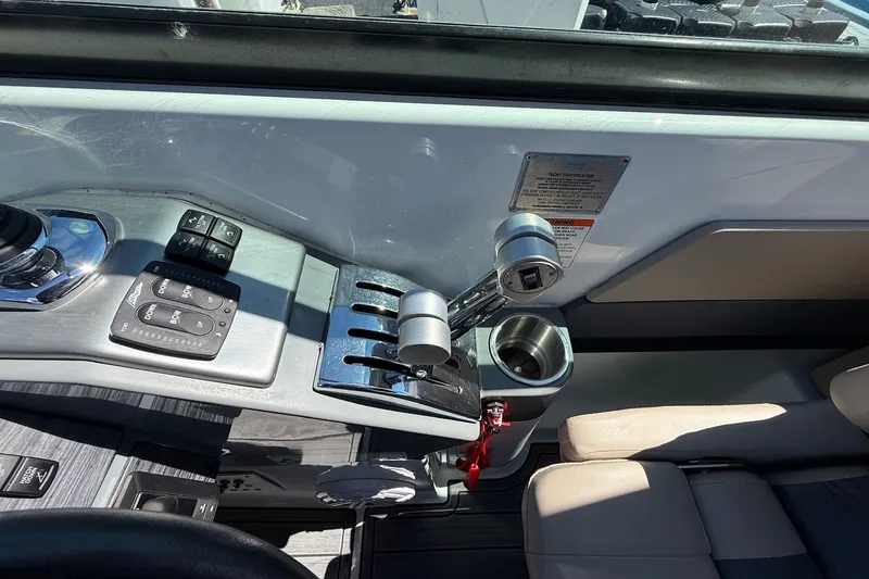Slide: The Image of Control panel of a 2013 Formula 310 Bowrider boat with throttle and cup holder. - 38