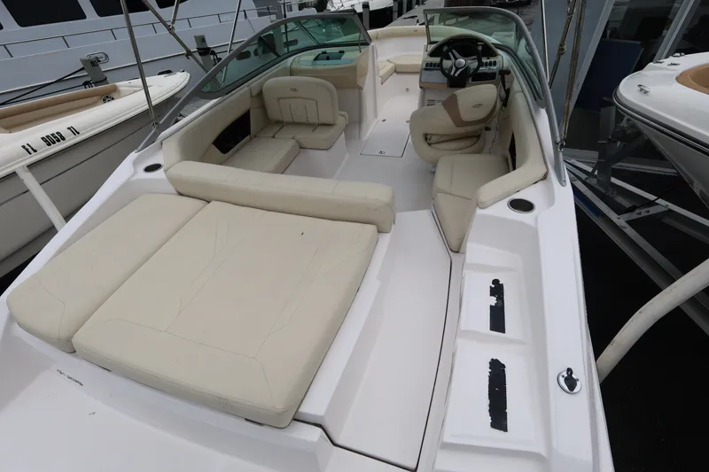 Slide: The Image of 2020 Regal 21 OBX boat interior with beige seating and modern dashboard. - 7