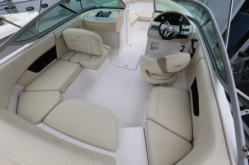Slide: The Image of 2020 Regal 21 OBX boat interior with beige seating and modern dashboard. - 9