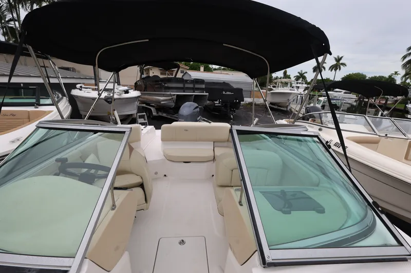 Slide: The Image of 2020 Regal 21 OBX boat with black canopy and spacious seating area. - 16