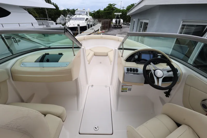Slide: The Image of Interior view of a 2020 Regal 21 OBX boat with steering wheel and seating. - 11