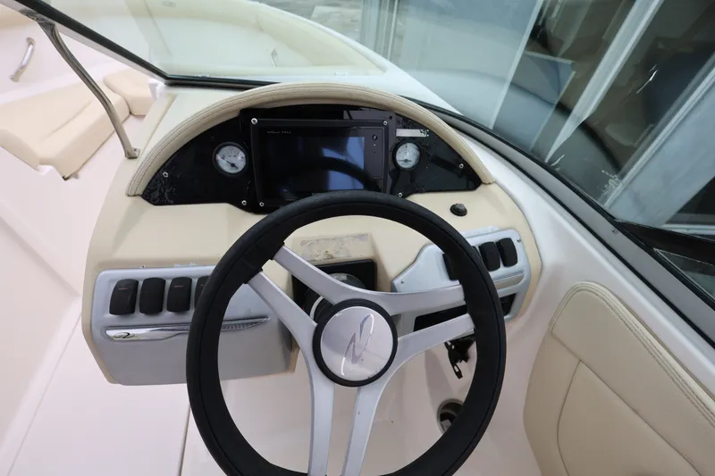 Slide: The Image of Cockpit view of 2020 Regal 21 OBX boat with steering wheel and dashboard controls. - 12