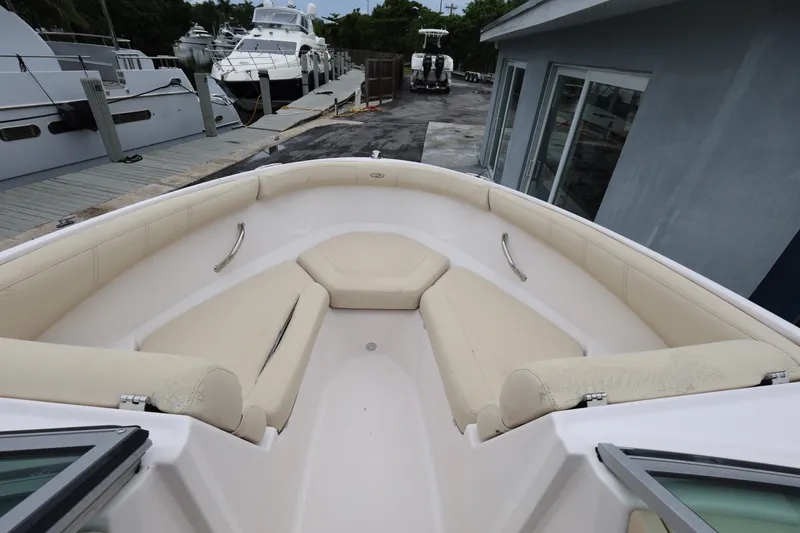 Slide: The Image of Bow seating area of a 2020 Regal 21 OBX boat, docked near other vessels. - 14