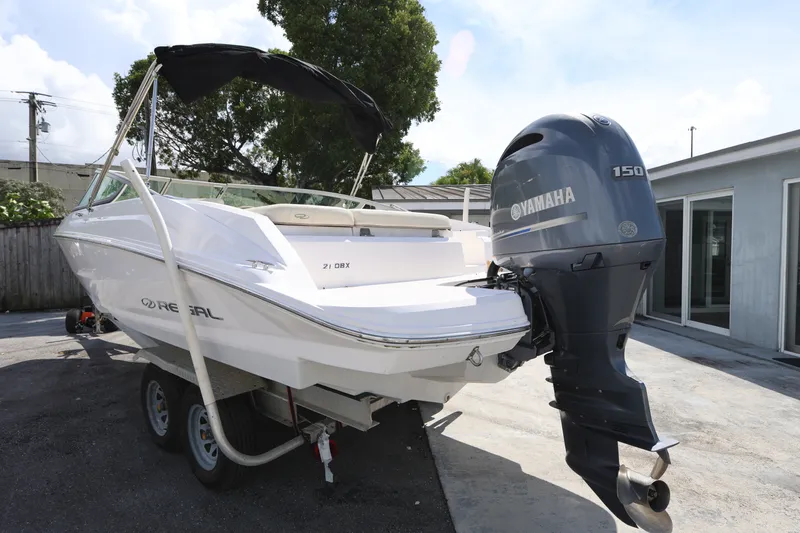 Slide: The Image of 2020 Regal 21 OBX boat with Yamaha 150 outboard motor on trailer. - 4