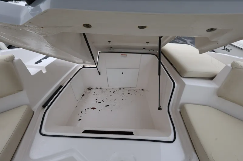 Slide: The Image of Open storage compartment on 2020 Regal 21 OBX boat, featuring spacious interior and cushioned seating. - 20