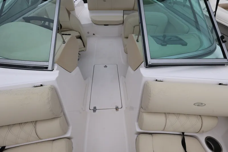 Slide: The Image of Interior view of a 2020 Regal 21 OBX boat with beige seating and windshield. - 15