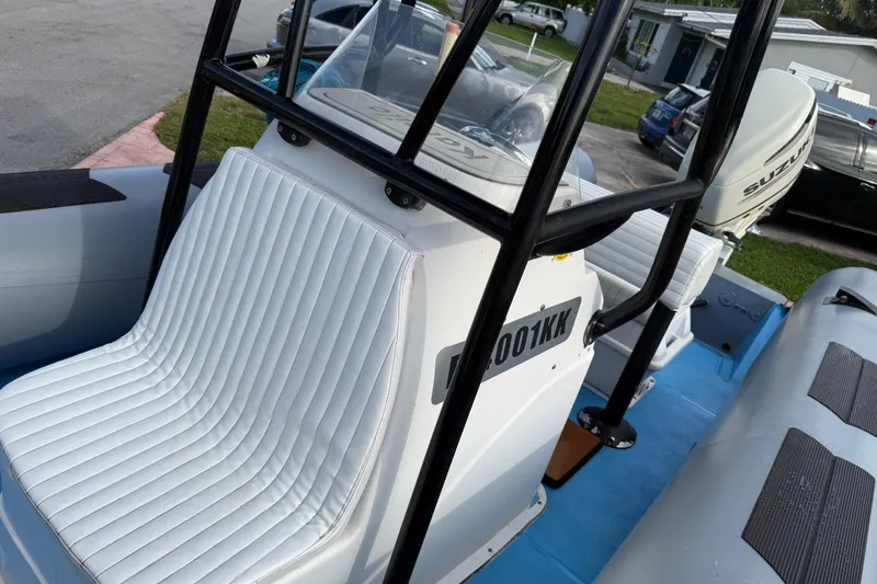 Slide: The Image of 1998 Novamarine SEVEN HD boat with white seating and Suzuki outboard motor. - 8