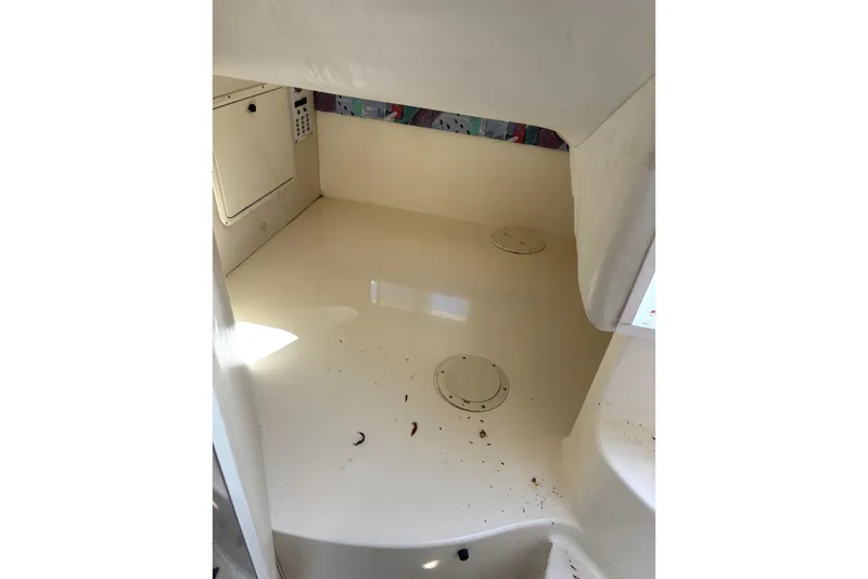 Slide: The Image of Interior cabin of a 1997 Donzi 255 LXC boat, showing storage compartments. - 16