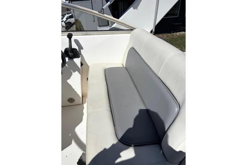 Slide: The Image of 1997 Donzi 255 LXC boat interior with white seating and control lever. - 13