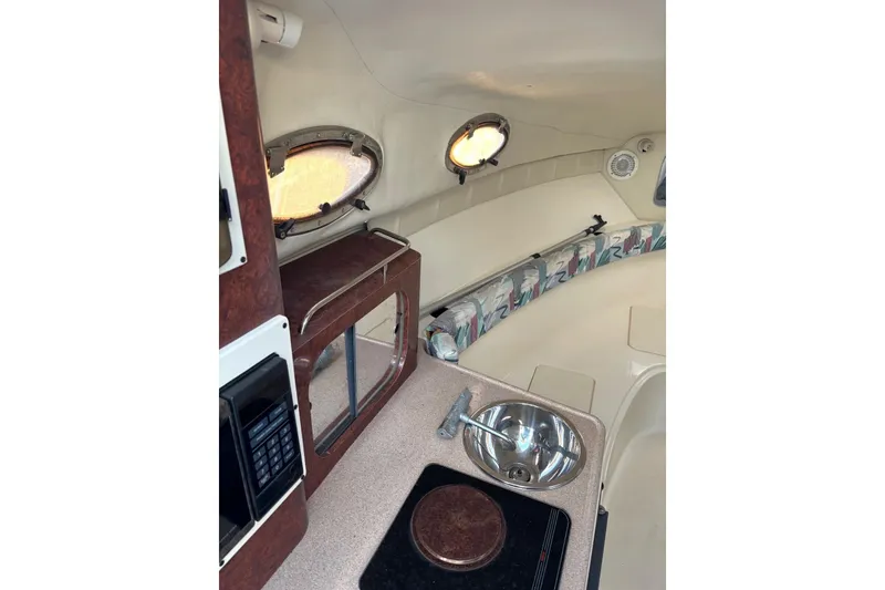 Slide: The Image of Interior of 1997 Donzi 255 LXC boat with kitchenette and seating area. - 22