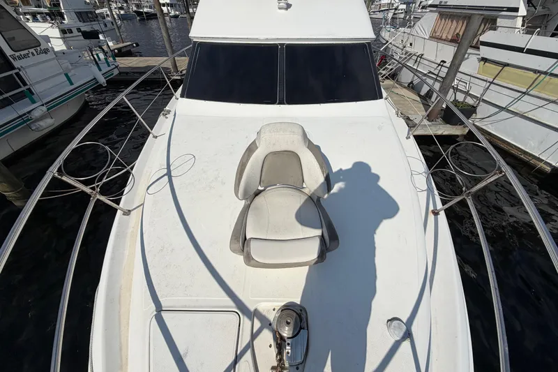 Slide: The Image of 1997 Sea Ray 370 Aft Cabin yacht deck with seating, docked at marina. - 20