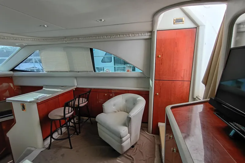 Slide: The Image of Interior of 1997 Sea Ray 370 Aft Cabin with elegant seating and cabinetry. - 51
