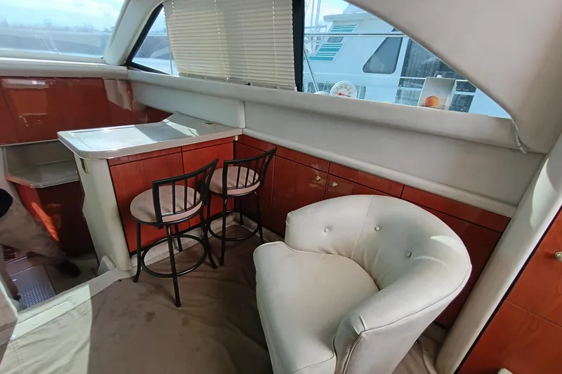 Slide: The Image of Luxurious 1997 Sea Ray 370 Aft Cabin interior with elegant seating and bar area. - 50