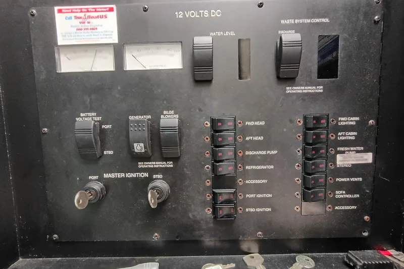 Slide: The Image of Control panel of a 1997 Sea Ray 370 Aft Cabin boat with switches and gauges. - 94