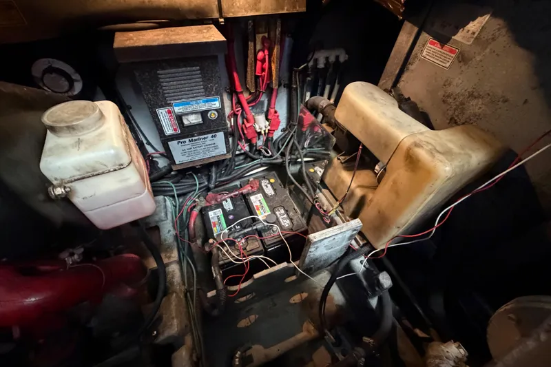 Slide: The Image of Engine compartment of a 1997 Sea Ray 370 Aft Cabin with batteries and wiring. - 99