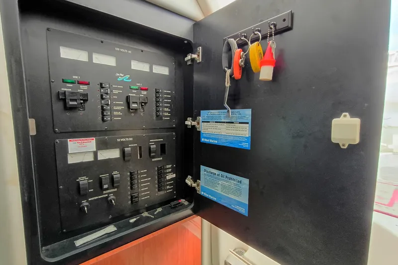 Slide: The Image of Electrical panel of 1997 Sea Ray 370 Aft Cabin with keys and notices. - 97