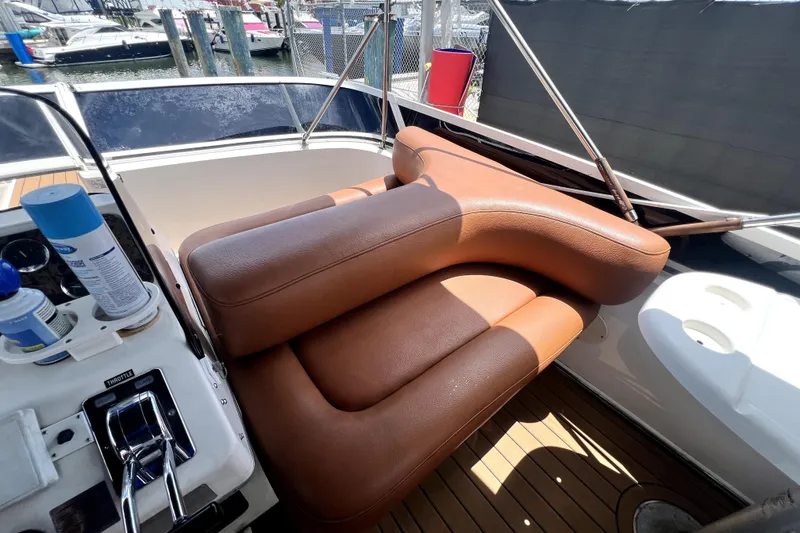 Slide: The Image of 1997 Sea Ray 450 Express Bridge interior with brown leather seating and control panel. - 32