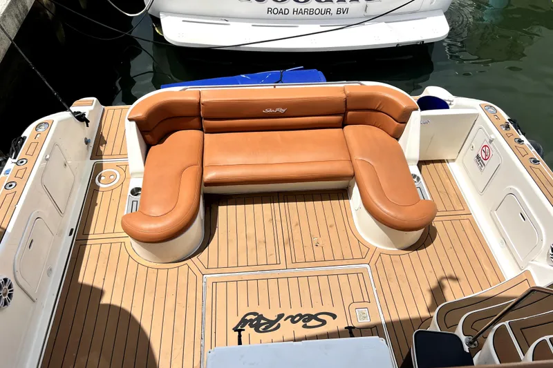 Slide: The Image of 1997 Sea Ray 450 Express Bridge with tan leather seating and teak deck in marina. - 17