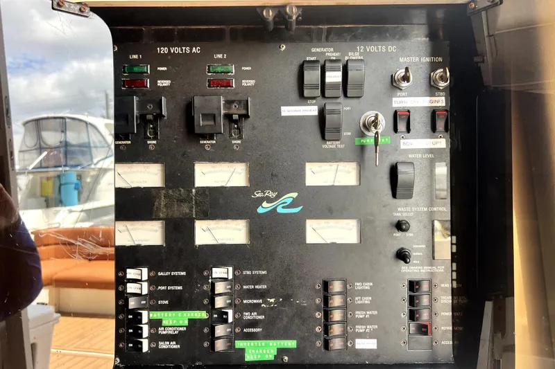 Slide: The Image of Control panel of a 1997 Sea Ray 450 Express Bridge yacht, featuring various switches and gauges. - 33