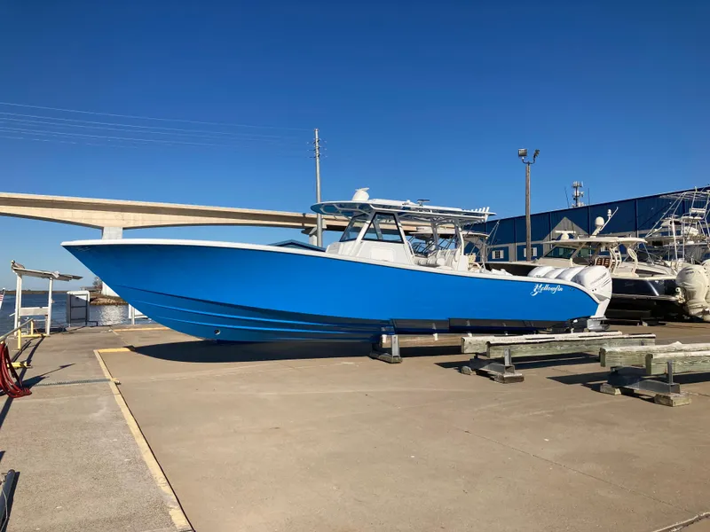 The Image of 2022 Yellowfin 39 Offshore boat in vibrant blue, docked under clear skies. - 0