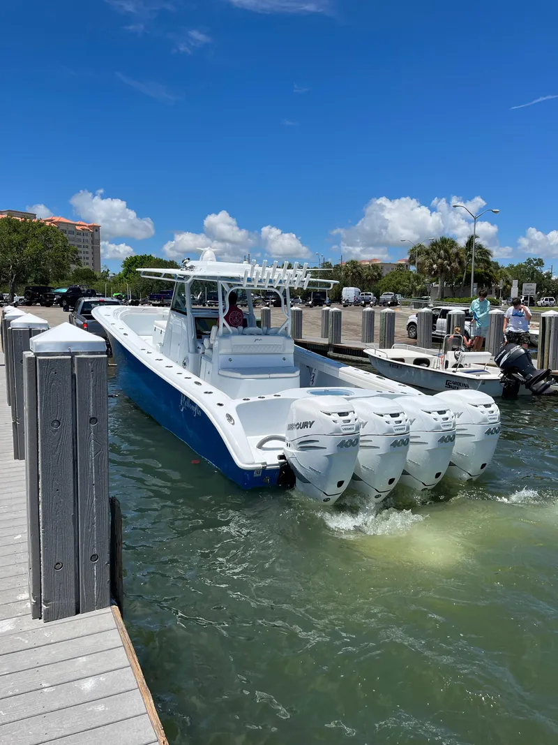 Slide: The Image of 2022 Yellowfin 39 Offshore boat with four engines docked in a marina. - 1