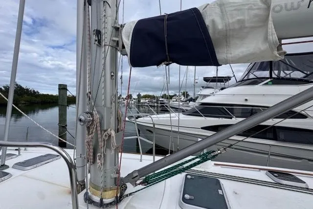 Slide: The Image of Beneteau 50 sailboat deck view, 1996 model, docked at marina with other boats. - 17
