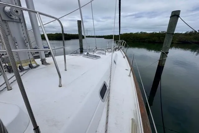 Slide: The Image of 1996 Beneteau 50 sailboat deck view, moored in calm waters. - 30