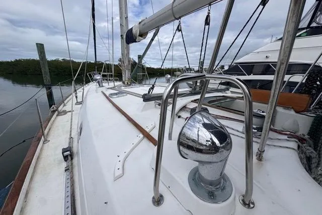 Slide: The Image of Sailboat deck view of 1996 Beneteau 50, docked with clear skies. - 13