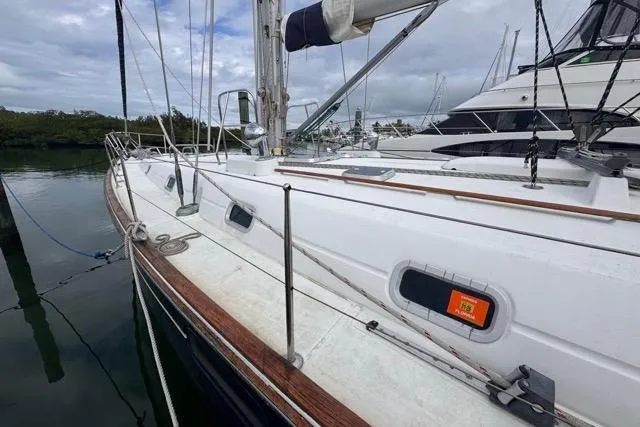 Slide: The Image of 1996 Beneteau 50 sailboat docked, showcasing deck and rigging details. - 8