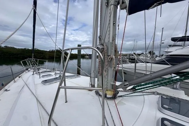 Slide: The Image of Sailboat deck view of a 1996 Beneteau 50 in a marina setting. - 19