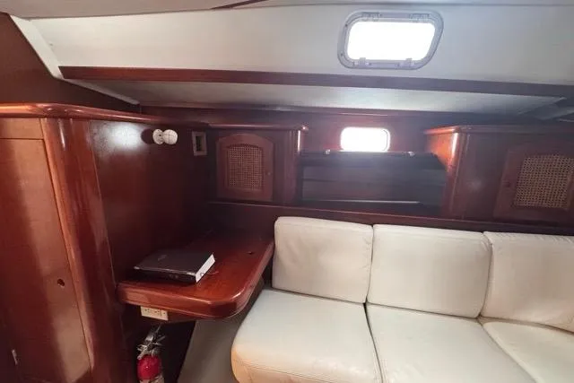 Slide: The Image of Interior of 1996 Beneteau 50 yacht with wooden cabinetry and white seating. - 88