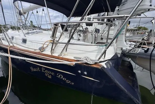 Slide: The Image of Beneteau 50 sailboat, 1996 model, docked with "Must Love Dogs" name on hull. - 5