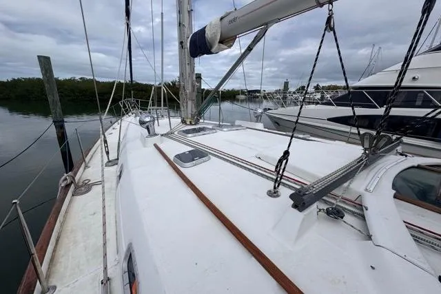 Slide: The Image of Sailboat deck view of 1996 Beneteau 50, docked with overcast sky. - 14